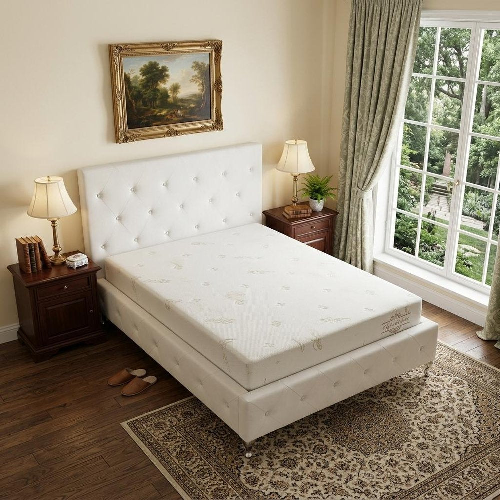 6" Full Double Aloe Vera Infused Medium Memory Foam Mattress styled in a furnished interior with a cream wall on a dark wood floor in white.