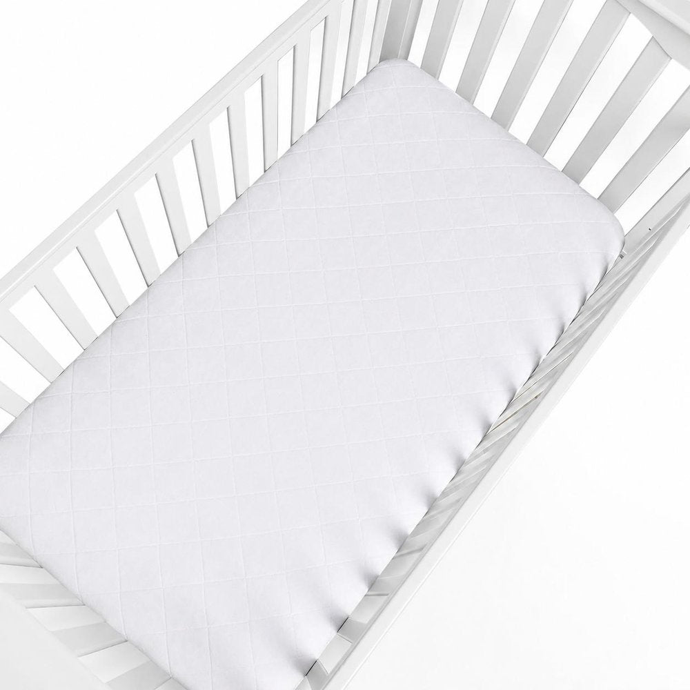 5" Deep Waterproof Bamboo Terry Cloth Crib Mattress Cover. Mattress protector isolated on a plain white background, in a white fabric finish.