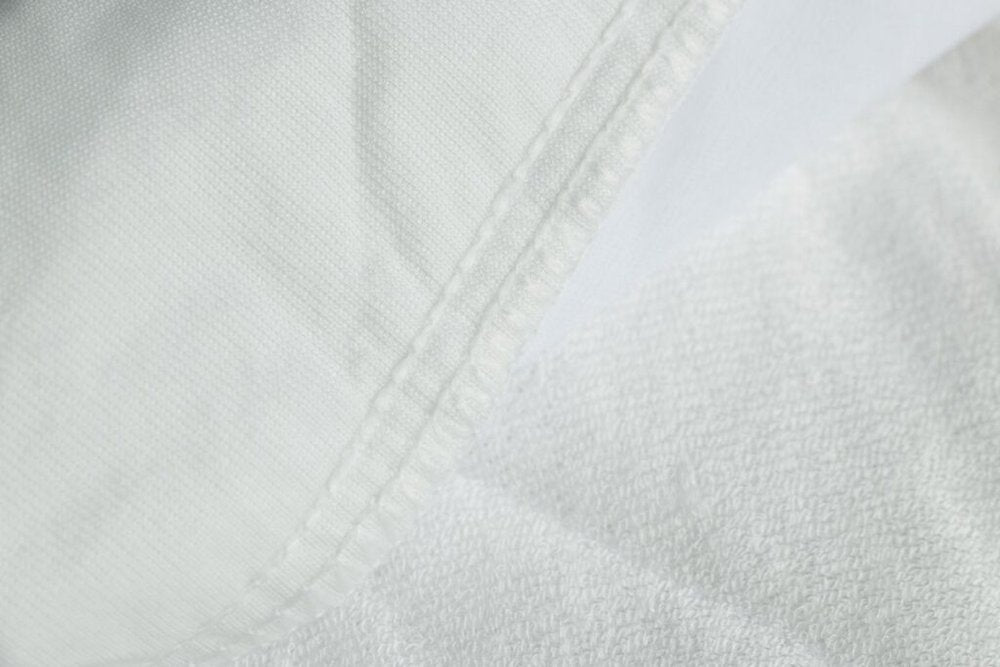 9" Deep Waterproof Bamboo Terry Cloth Crib Mattress Cover on a white background
