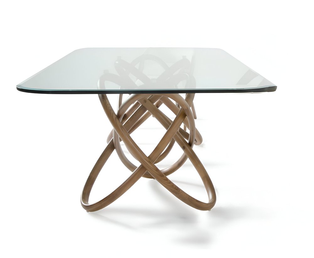 A rectangular glass dining table with a natural wood pedestal base on a white background.