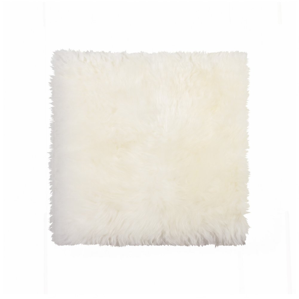 White fluffy square pillow with shaggy texture on a white background.