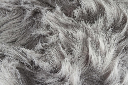 Close-up of a gray faux fur fabric with a soft, fluffy texture.