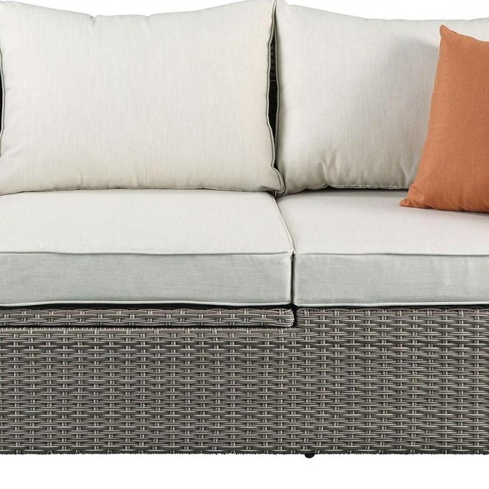 Three Piece Outdoor Gray Wicker Sectional Seating Group with Beige Cushions close-up detail