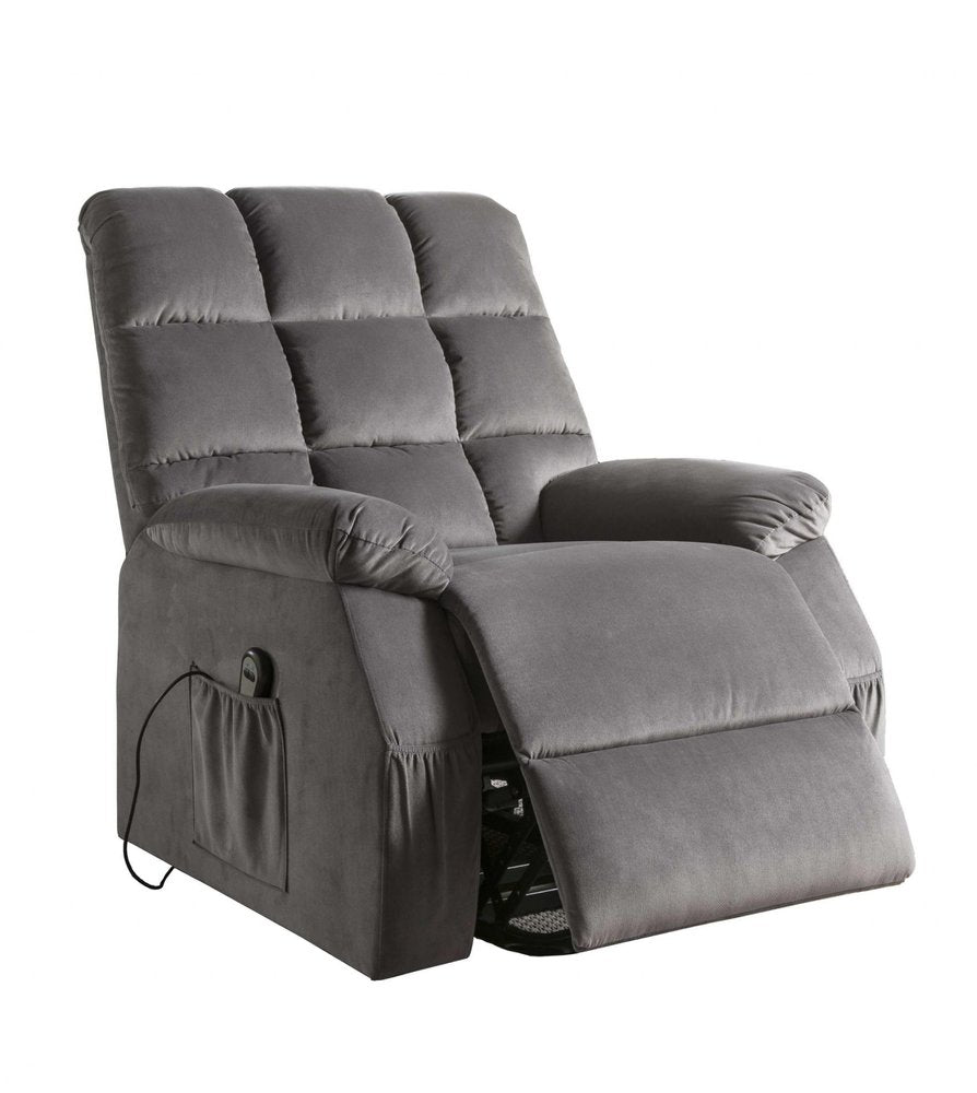 Gray velvet power recliner with heating and massage functions, featuring side pockets and a remote control, on a white background.