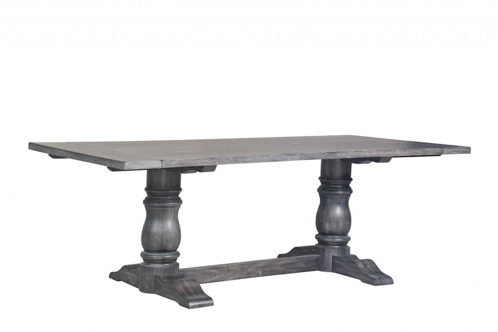 Rectangular dark gray solid wood dining table with a trestle base on a white background.