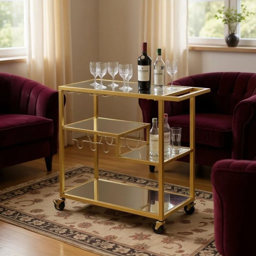 40" Clear and Gold Glass and Iron Rolling Prep Table styled in a furnished interior with a tan wall on a wood floor.