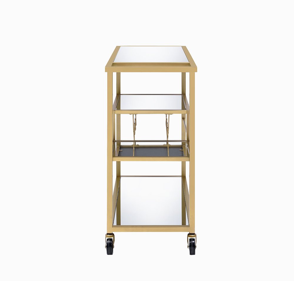 A gold metal and glass rolling prep table with three shelves and wheels on a white background.