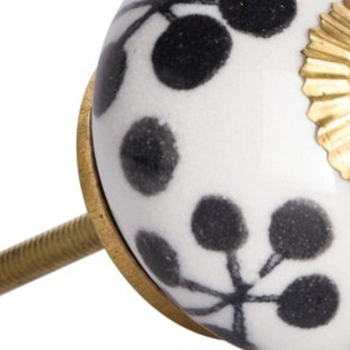 Close-up of 1.5" X 1.5" X 1.5" White Black And Yellow Knobs 12 Pack showing the black ceramic face.
