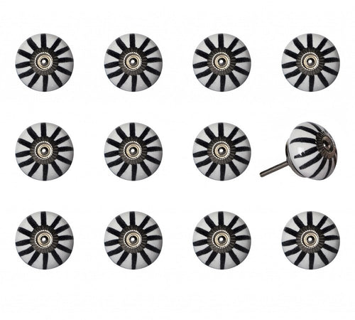 Twelve white ceramic cabinet knobs with black stripes and silver hardware on a white background.