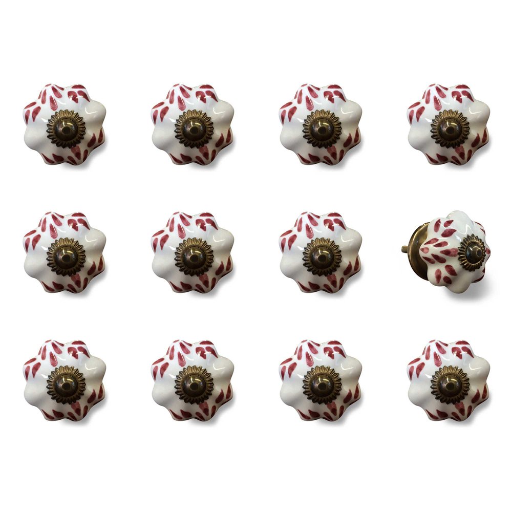Set of twelve white ceramic drawer knobs with burgundy floral pattern and copper center on a white background.