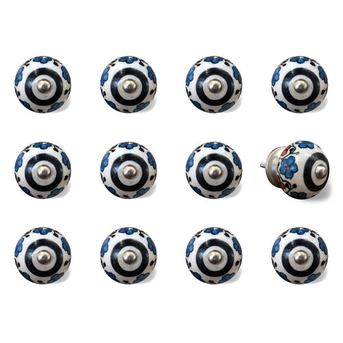 Twelve white ceramic cabinet knobs with black and navy blue floral pattern and silver center, on a white background.