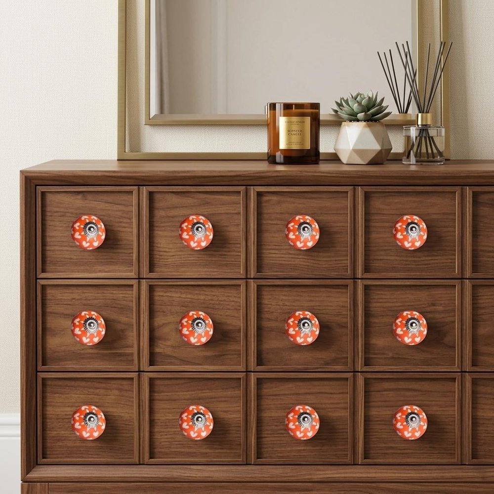 Set of Twelve Orange White And Silver Floral Ceramic Drawer Pull Knobs in a home interior