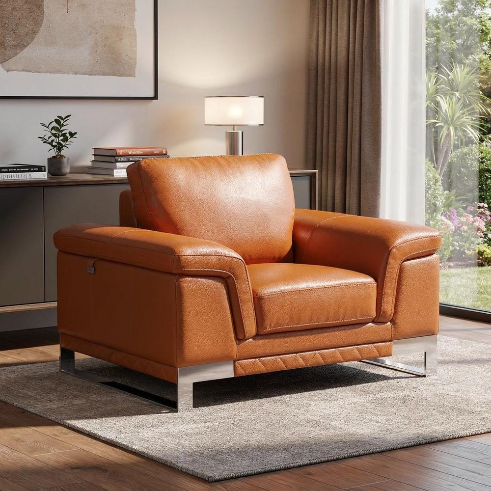 49" Brown And Silver Genuine Leather Arm Chair styled in a furnished interior on a dark wood floor against a tan wall.