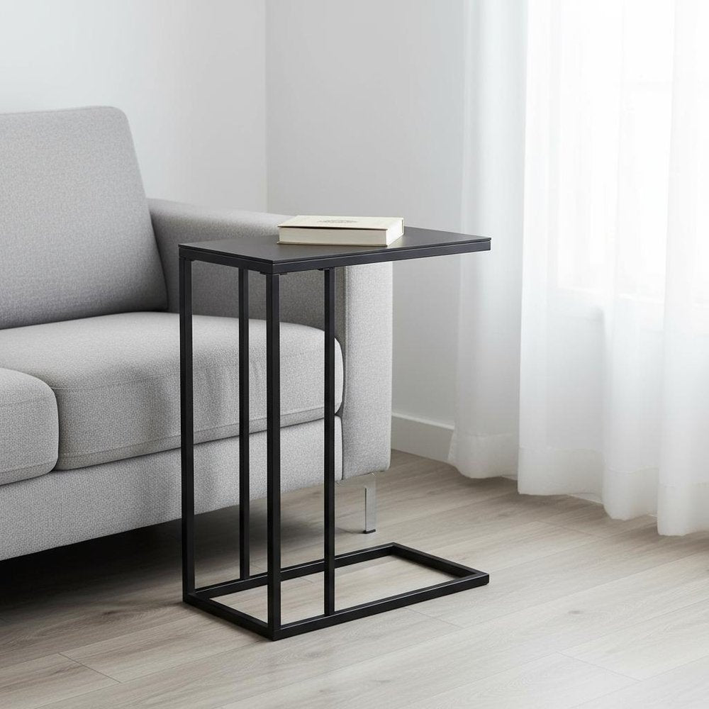 Cropped view of 18.25" X 10.25" X 24" Black Metal Tempered Glass Accent Table focusing on the glass surface.