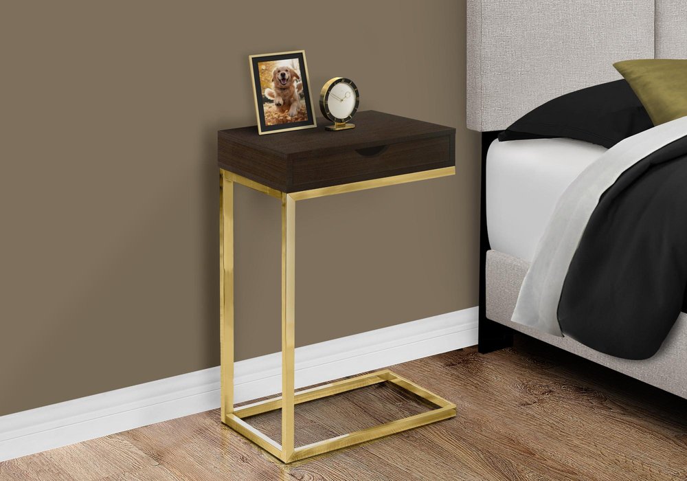10.25" X 15.75" X 24.5" Cappuccino Finish And Gold Laminated Drawer Accent Table styled in a furnished interior with a brown wall on a wood floor.