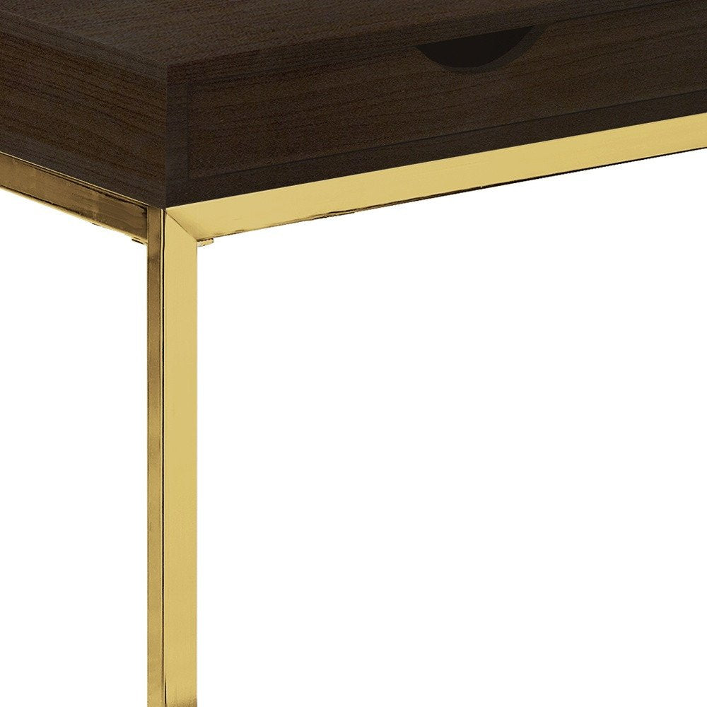 Close-up of a cappuccino finish drawer accent table with gold metal legs and frame against a white background.