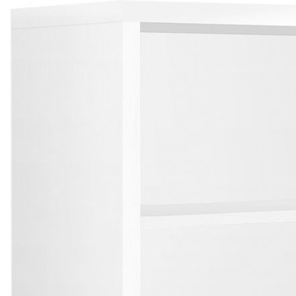 Close-up of a white wood four-tier bookcase, showing the side and shelves.