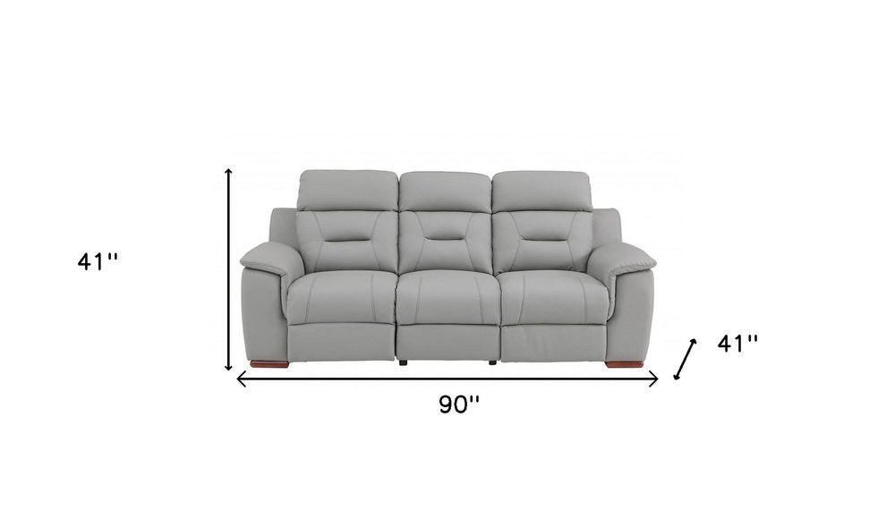 Gray faux leather reclining sofa with brown legs, 90 inches wide and 41 inches high.