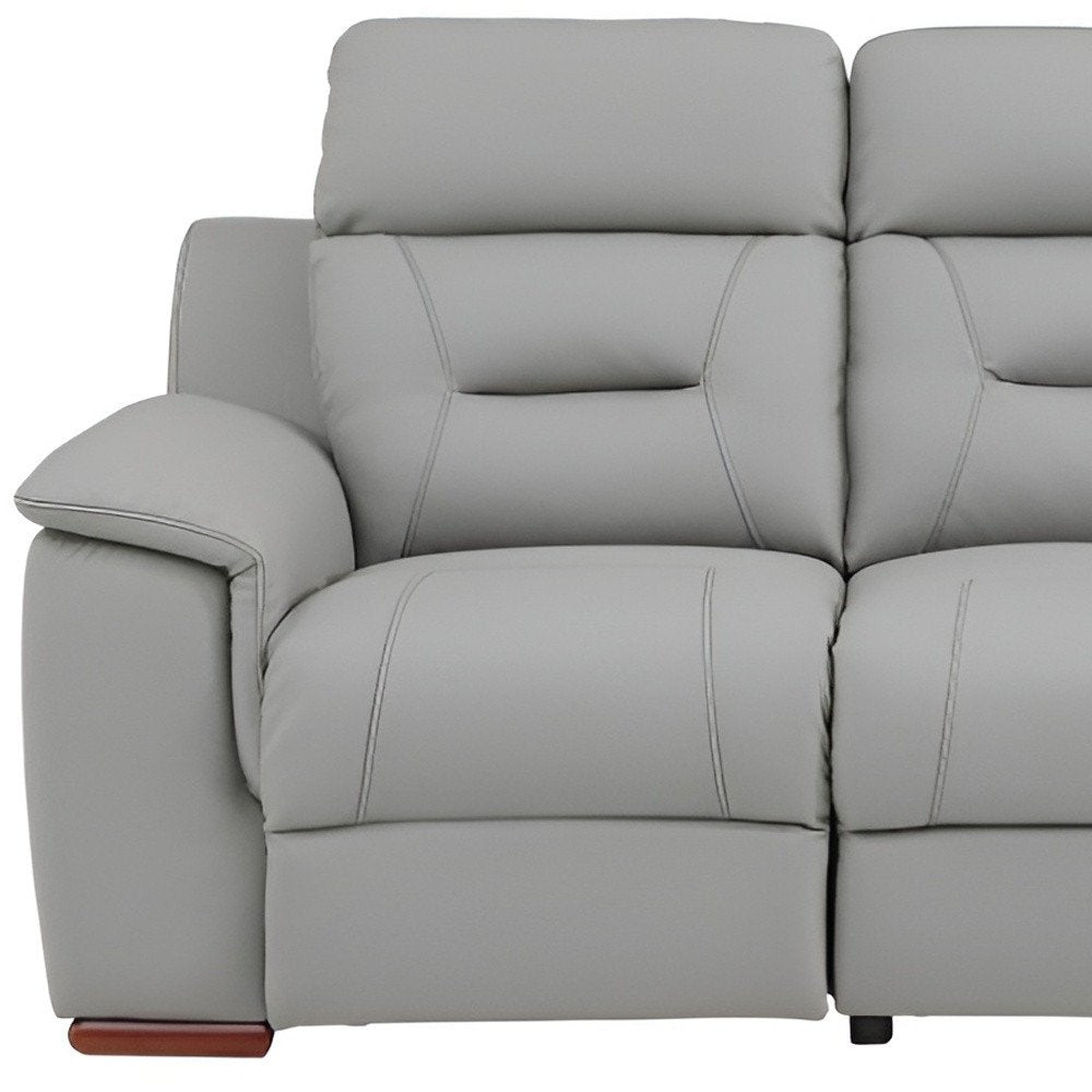 90" Gray Faux Leather Reclining Sofa With Brown Legs close-up detail