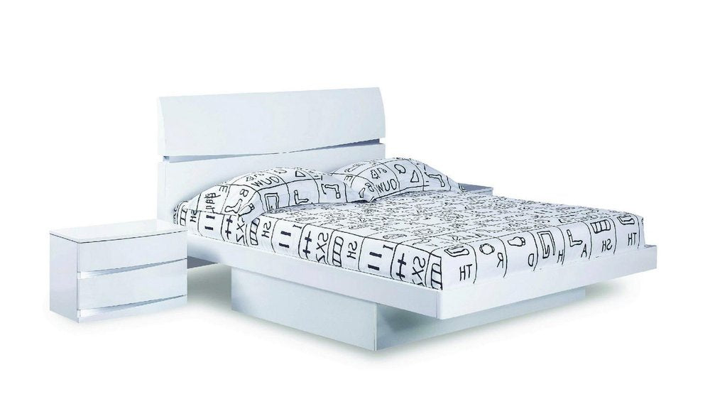 White solid wood king bed frame with a modern design and a patterned duvet, shown against a white background.