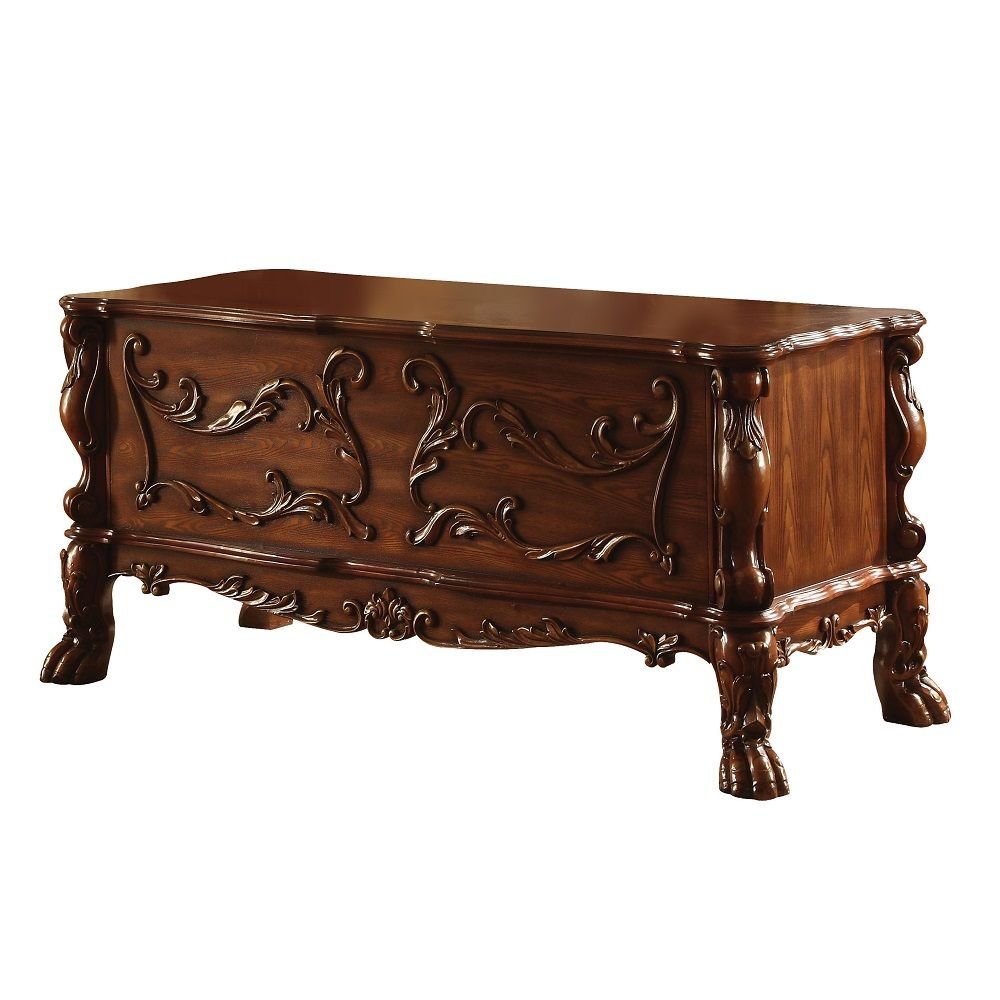 Ornate wooden chest with carved details and claw feet, set against a white background.