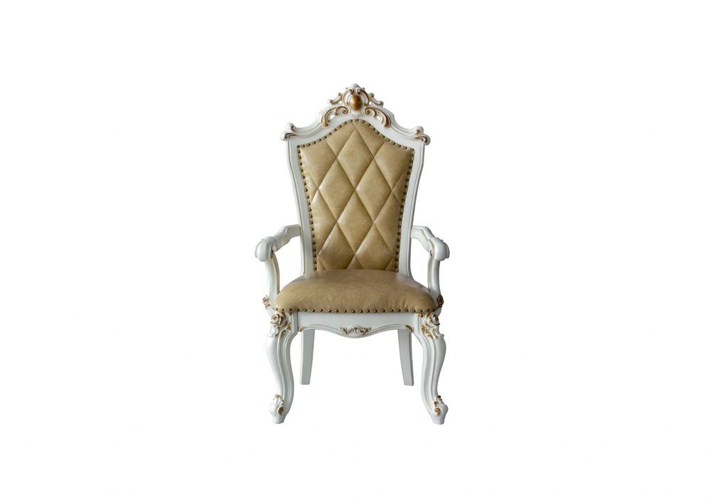 White and gold ornate armchair with tufted tan faux leather seat and back on a white background.