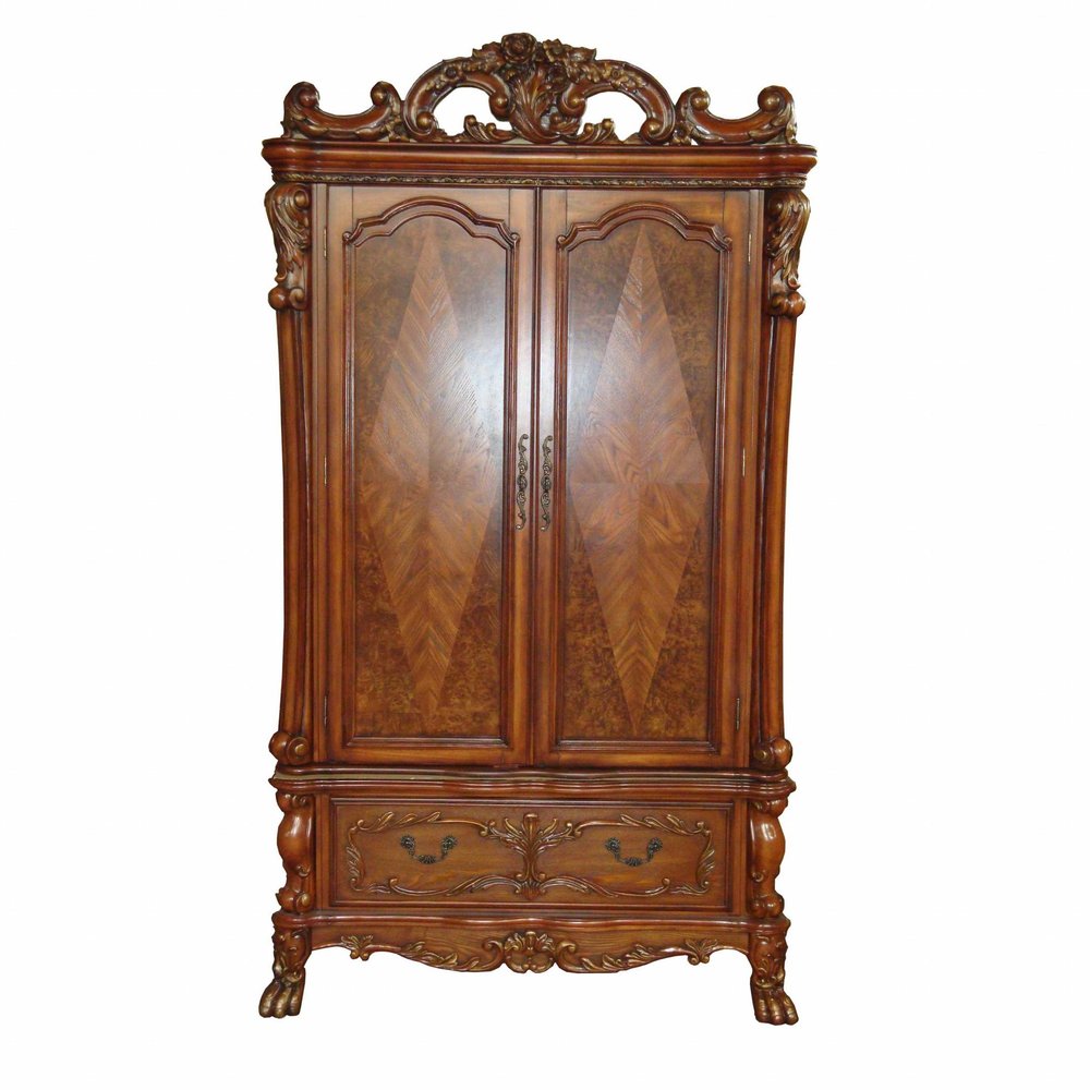 Brown wood accent cabinet with two doors and ornate carvings, set against a white background.