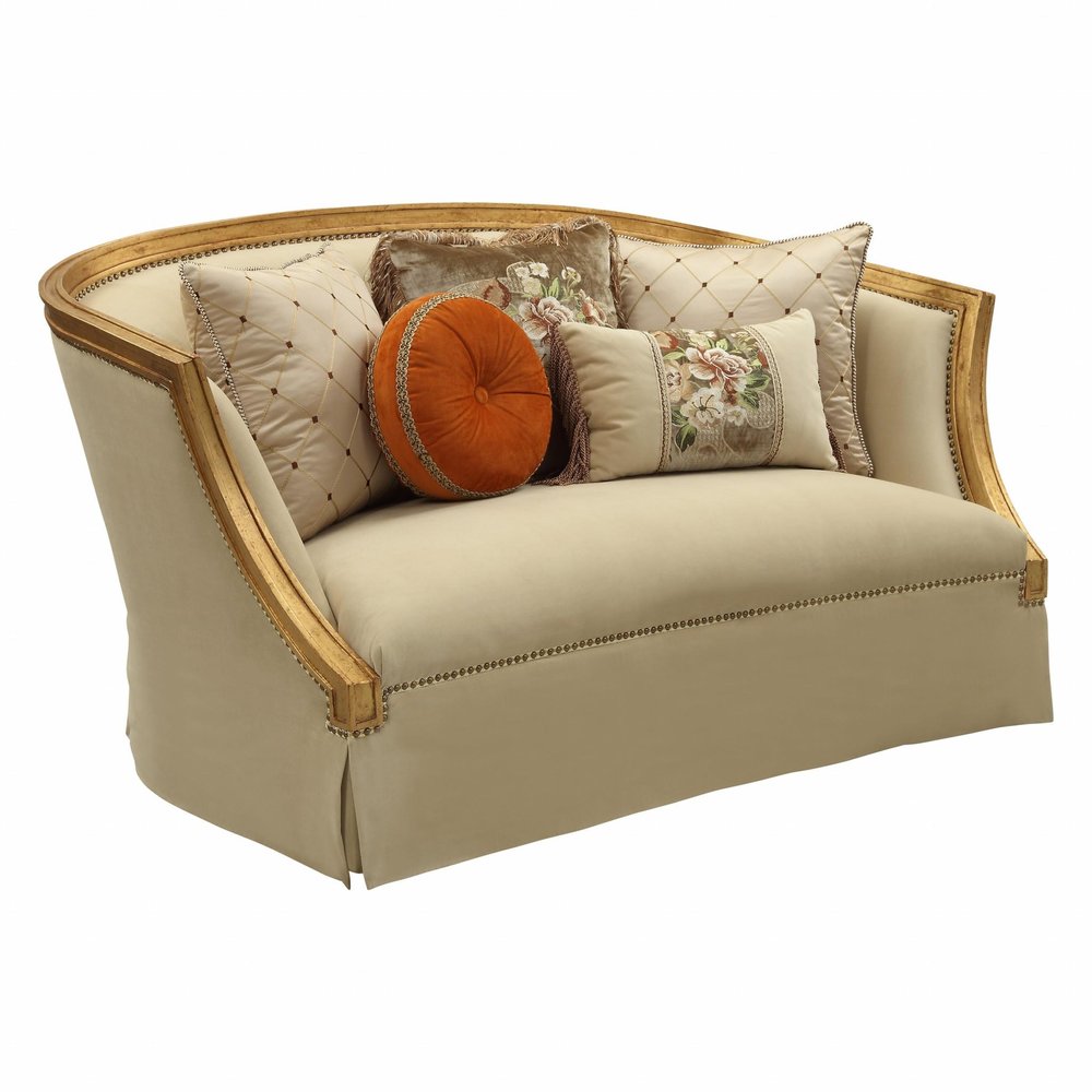 70" Tan And Gold Curved Loveseat and Toss Pillows on a white background