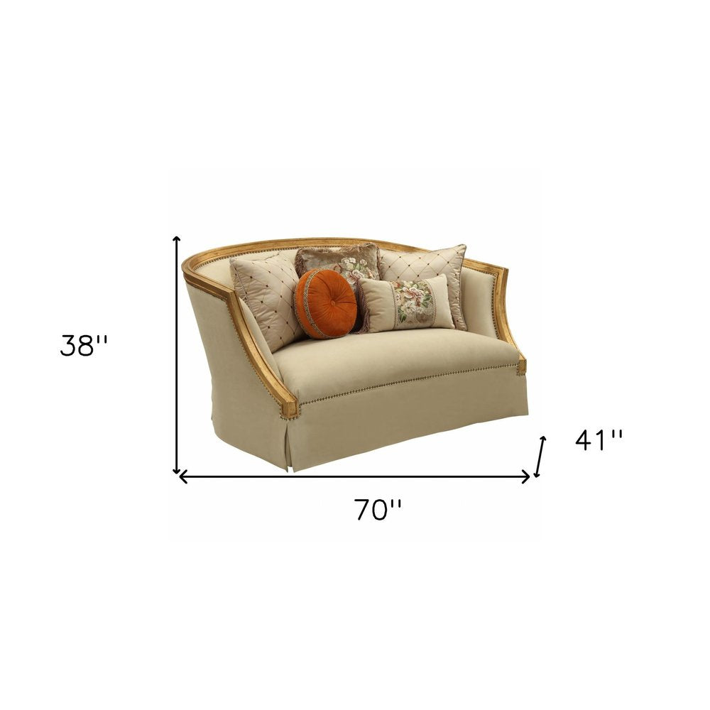 70" Tan And Gold Curved Loveseat and Toss Pillows on a white background
