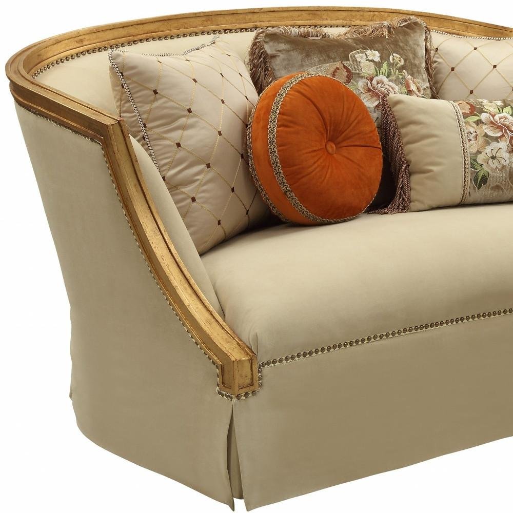 70" Tan And Gold Curved Loveseat and Toss Pillows on a white background