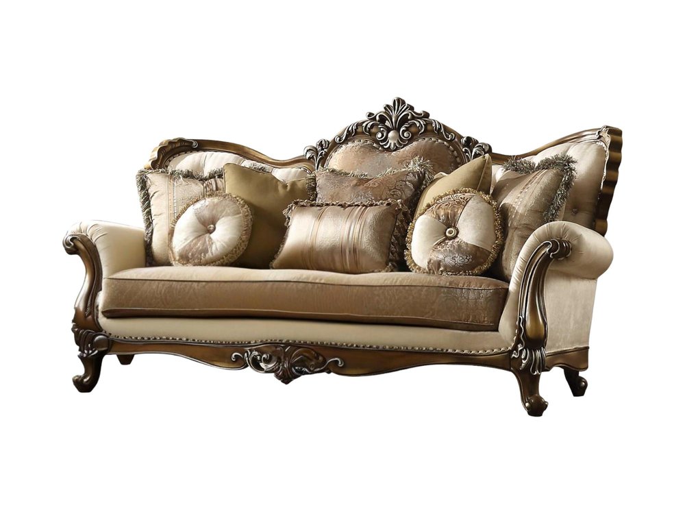 A tan polyester blend curved sofa with ornate brown legs and multiple decorative toss pillows on a white background.
