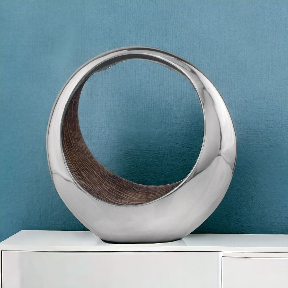 16" Silver and Brown Buffed Aluminum Tabletop Sculpture shown outdoors on an outdoor setting.