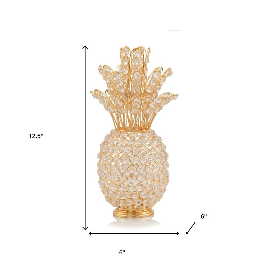 13" Gold and Faux Crystal Pineapple Tabletop Sculpture. Sculpture isolated on a plain white background, finished in gold crystal.
