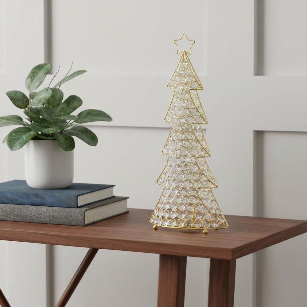 16" Glam Silver And Faux Crystals Christmas Tree Tabletop Sculpture styled in a furnished interior with an off-white wall on a tiled floor.
