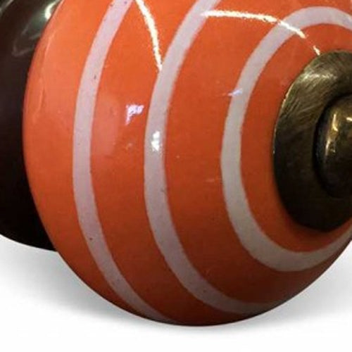 Cropped view of 1.5" X 1.5" X 1.5" Ceramic Metal Multicolor 12 Pack Knob focusing on the orange ceramic surface.