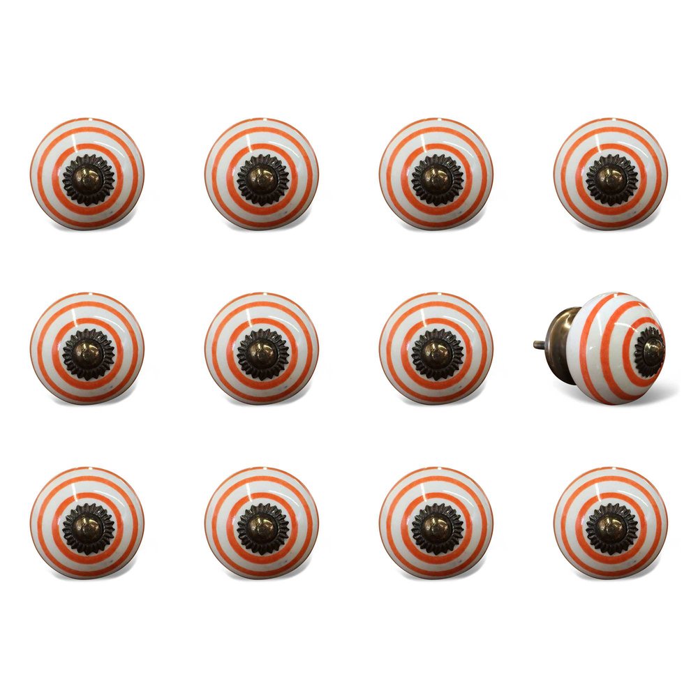 Twelve orange and white ceramic drawer knobs with geometric pattern and brass hardware on a white background.