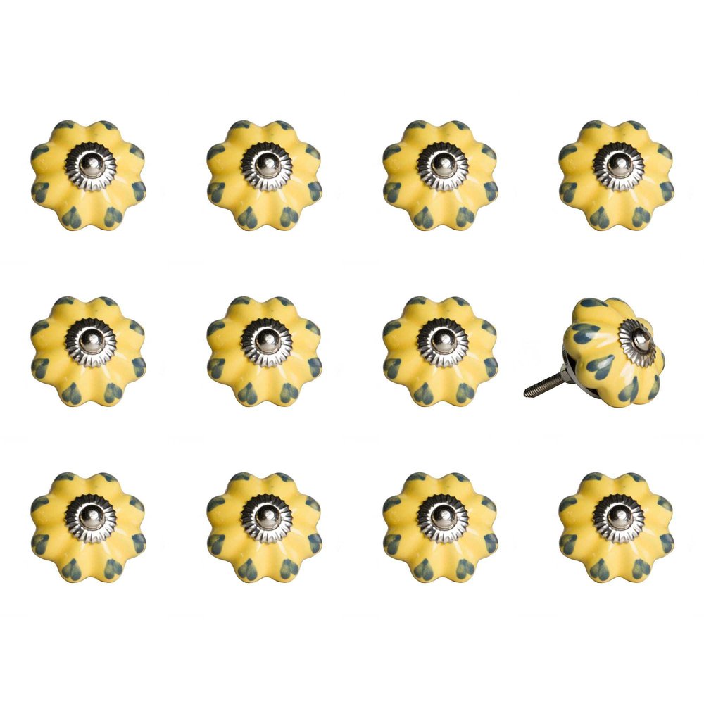 Twelve yellow ceramic drawer knobs with green accents and silver hardware on a white background.