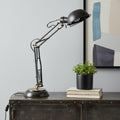 33" Black Metal Desk Table Lamp With Black Bowl Shade displayed on a tabletop in a furnished interior against an off-white wall.