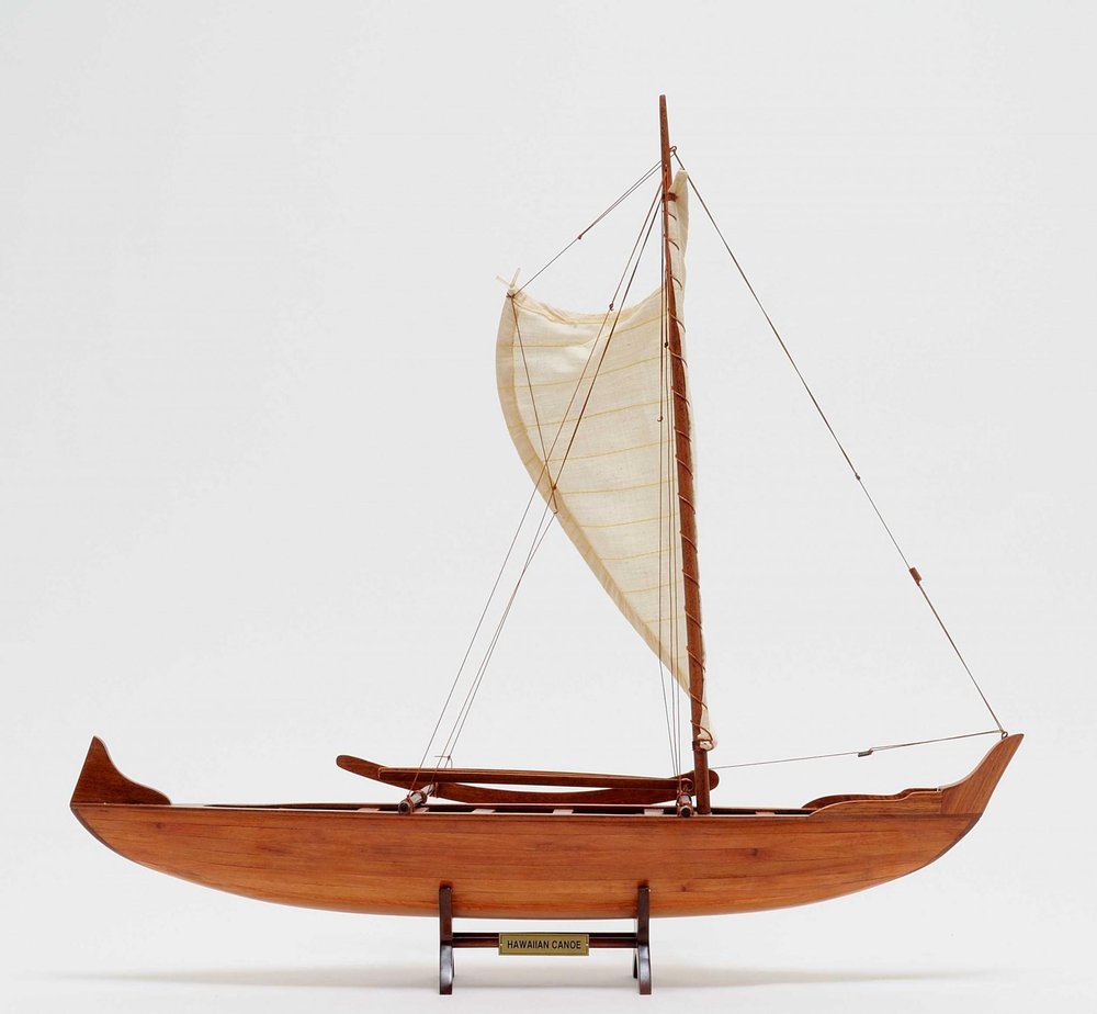 10" X 25.25" X 24" Hawaiian Canoe. Home product isolated on a plain white background, showing its dark brown color.