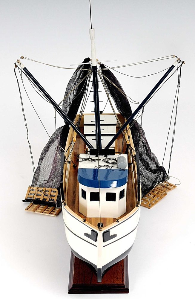 22" Black And White Solid Wood Hand Painted Model Boat. Home product isolated on a plain white background, finished in black wood.