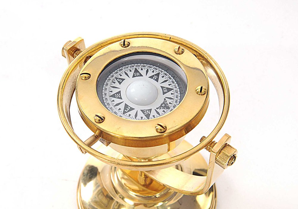 4.5" X 5" X 5.5" Gimbaled Compass. Sculpture isolated on a plain white background, finished in gold metal.