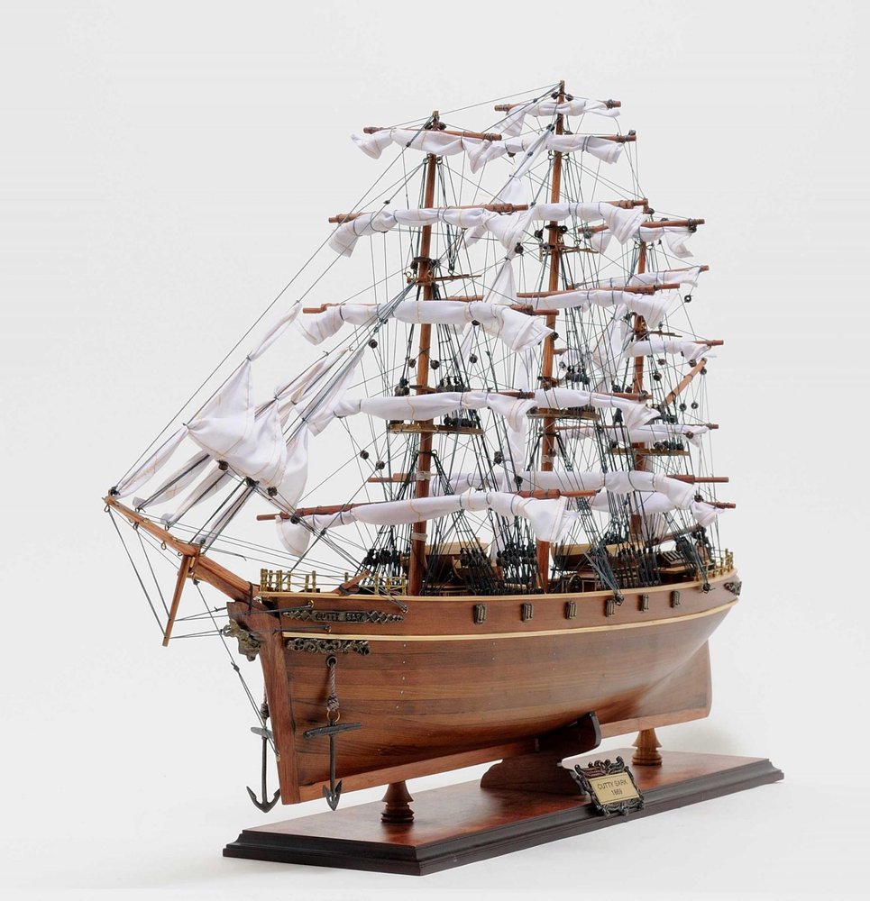 28" Brown Solid Wood Hand Painted Model Boat. Sculpture isolated on a plain white background, in a brown wood finish.