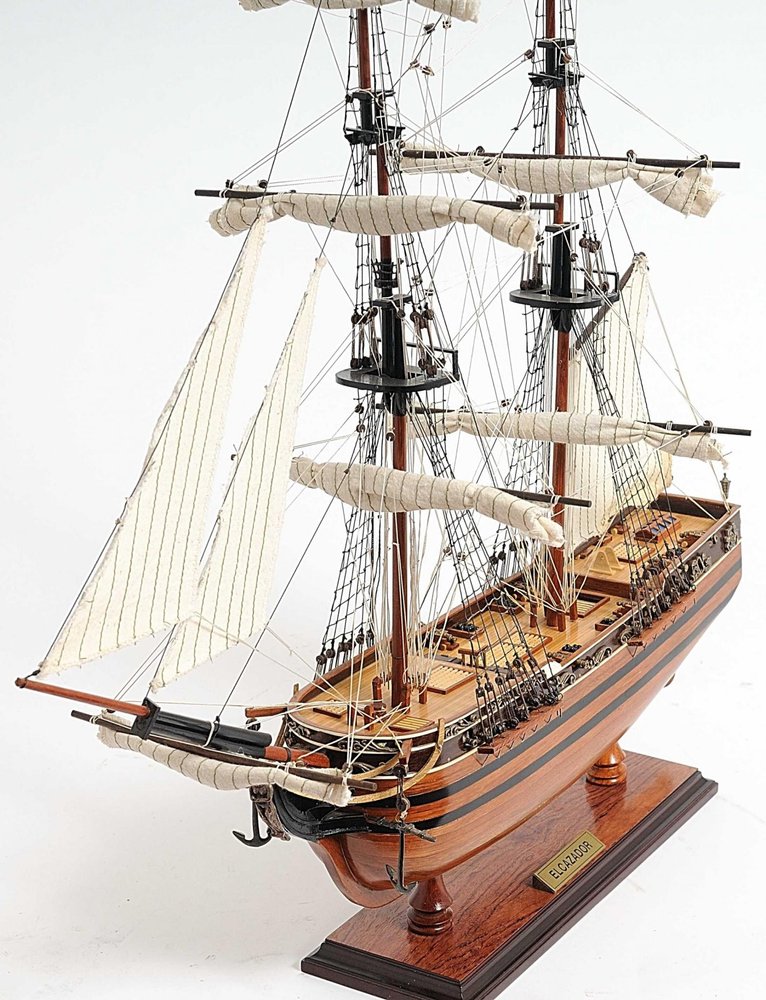 24" Brown Solid Wood Hand Painted Boat Model Boat. Home product isolated on a plain white background, showing a brown wood surface.