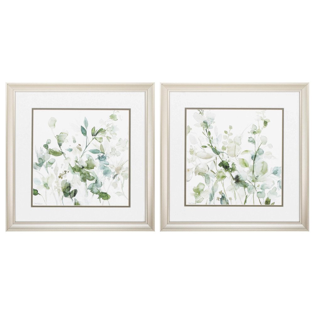 Set of two framed watercolor wall art with champagne-colored frames depicting light green and white floral arrangements.