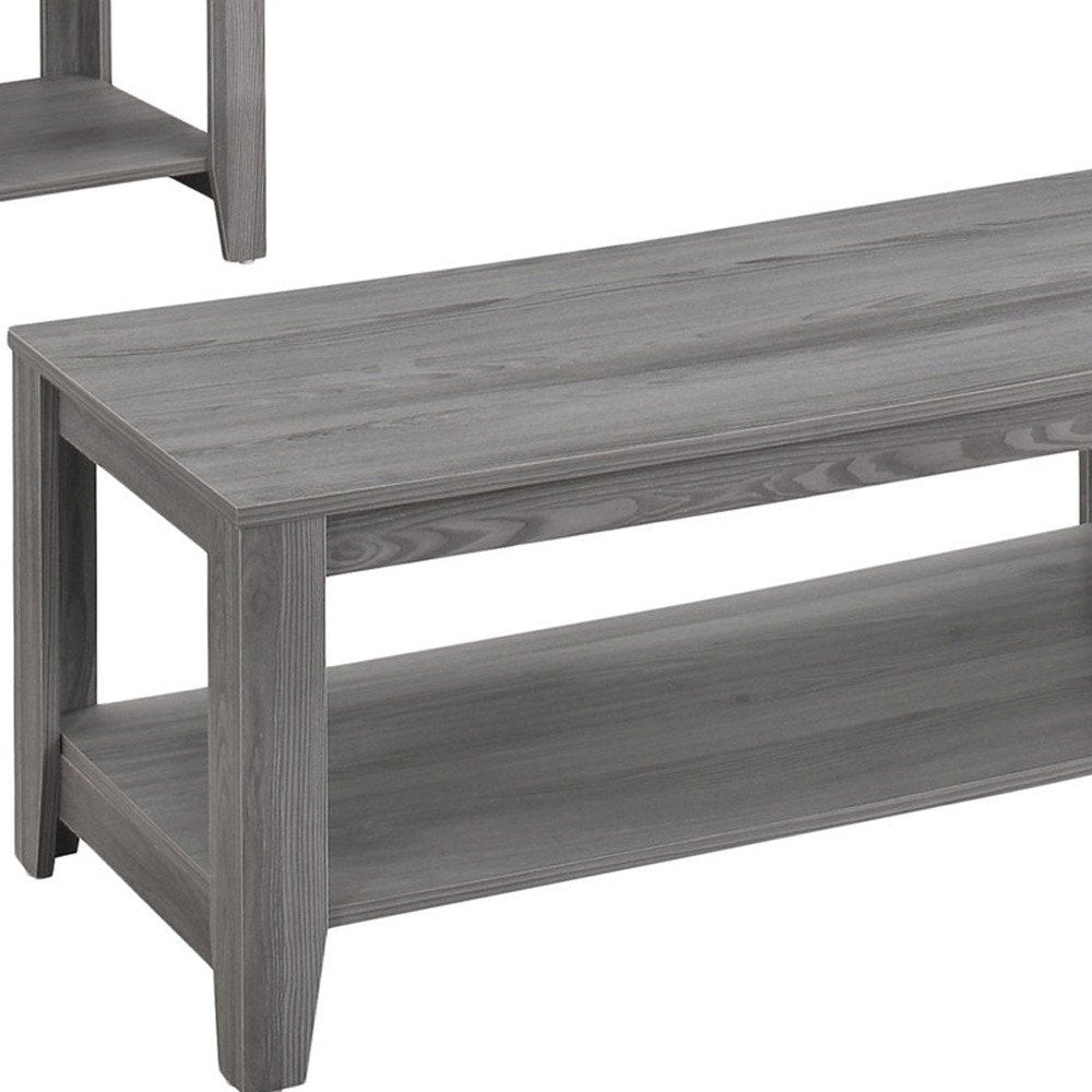 Gray coffee table with a shelf, made of wood with a visible grain finish, on a white background.