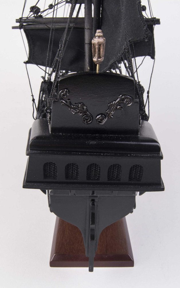 Cropped view of 19" Black Solid Wood Hand Painted Model Boat focusing on the black wood surface.