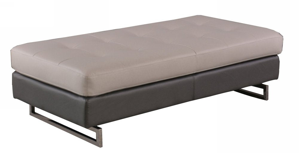 Rectangular taupe and brown faux leather tufted ottoman with silver metal legs on a white background.