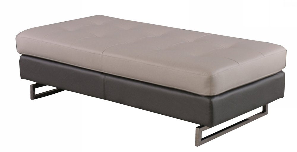 63" Taupe Brown and Silver Faux Leather Tufted Ottoman. Ottoman isolated on a plain white background, in a taupe faux leather finish.