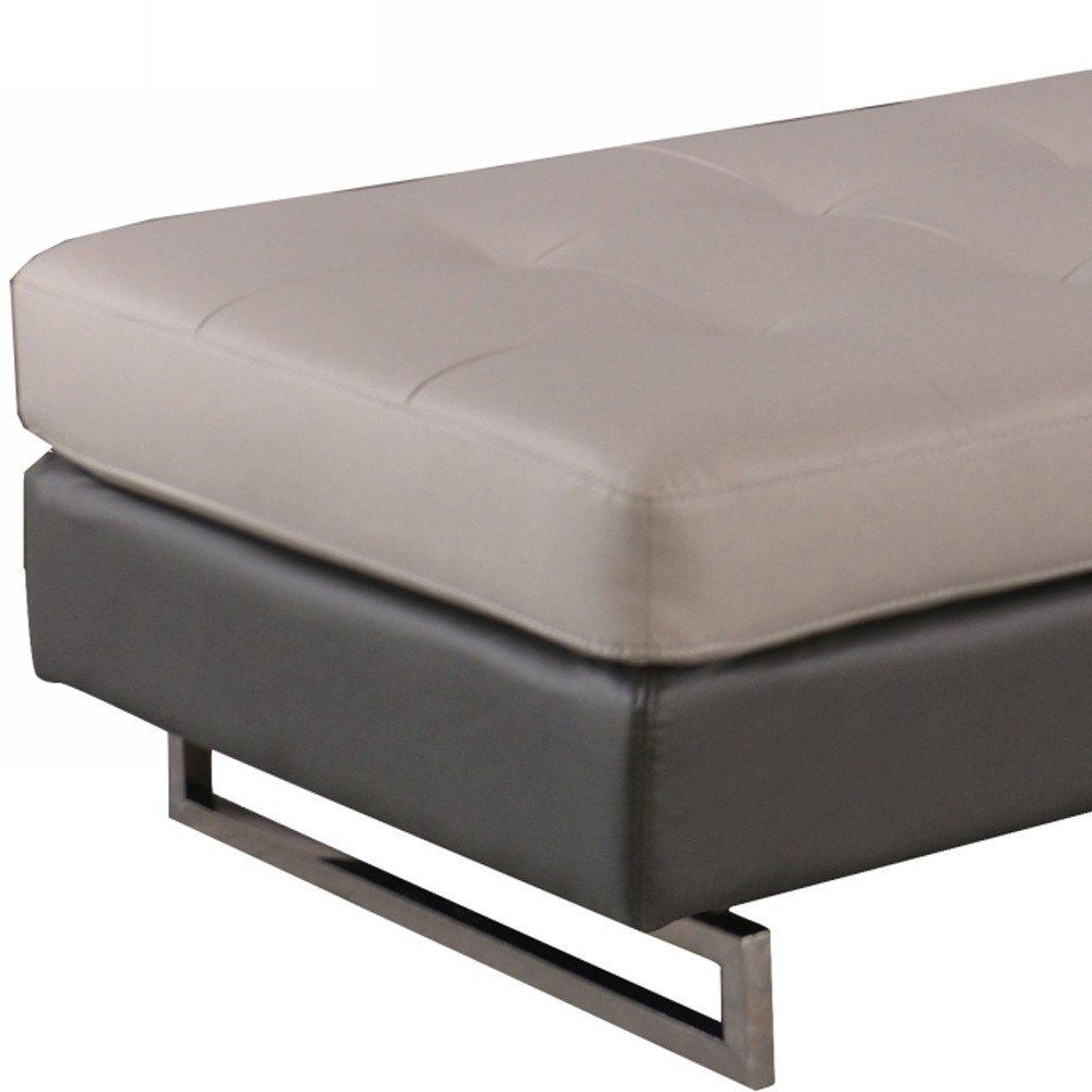 63" Taupe Brown and Silver Faux Leather Tufted Ottoman. Ottoman isolated on a plain white background, showing a taupe faux leather surface.