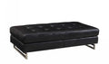 63" Black Tufted Faux Leather and Silver Ottoman. Ottoman isolated on a plain white background, in a silver faux leather finish.